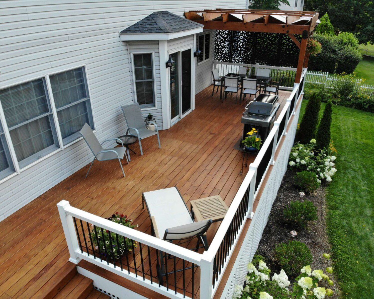 A newly installed back porch with maple wood, and multiple chairs for relaxing