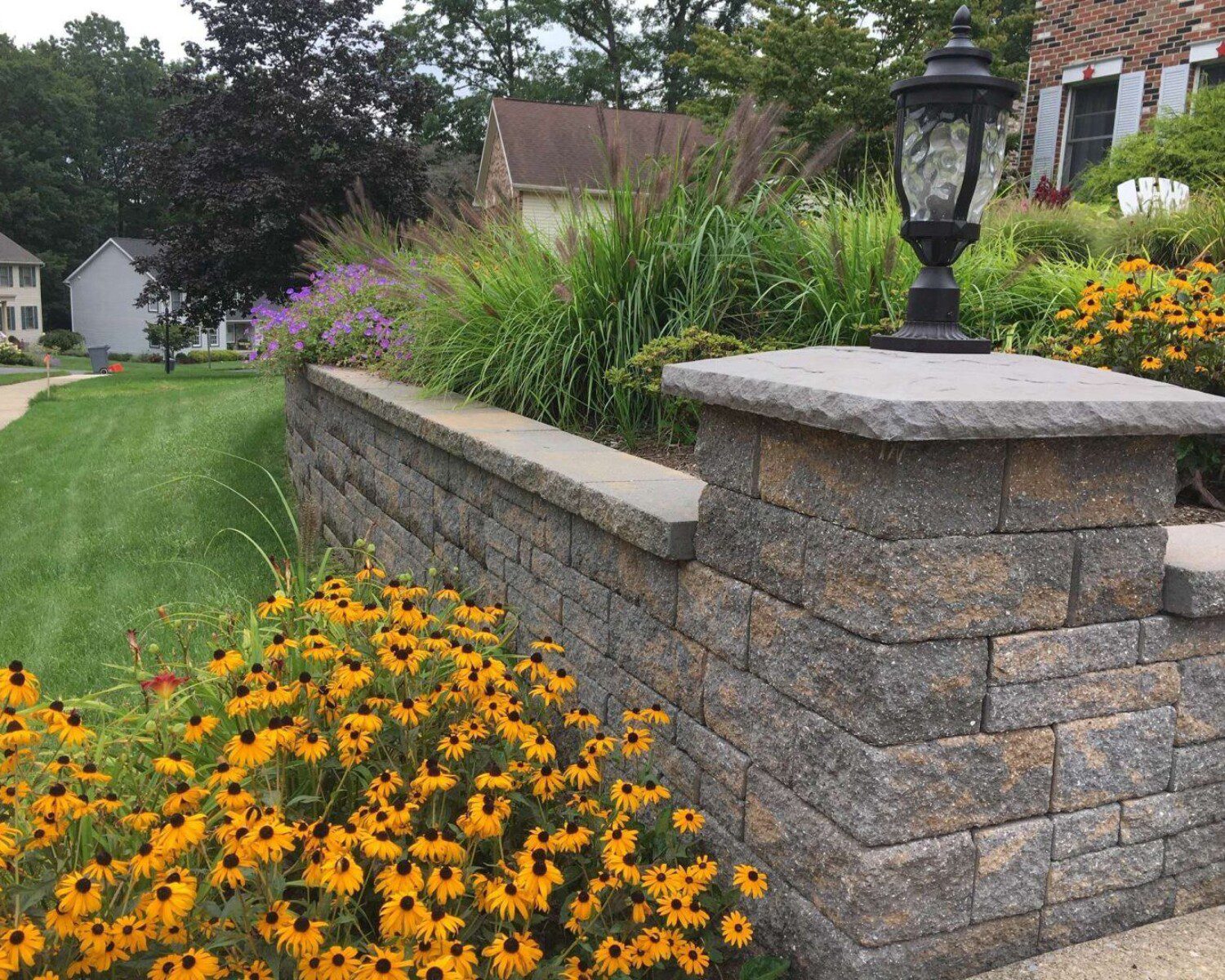 A newly installed stone wall with flowers